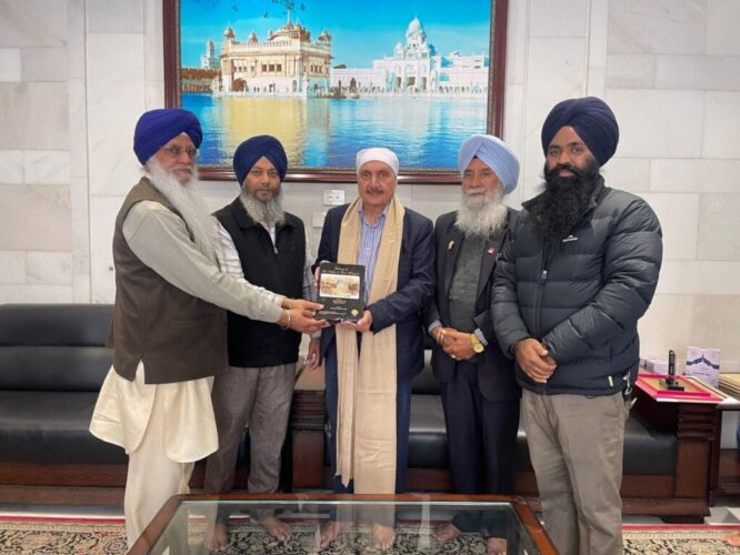 Speaker of the British Columbia Legislative Assembly, Raj Chouhan, bows at Sachkhand Sri Harmandar Sahib with his family