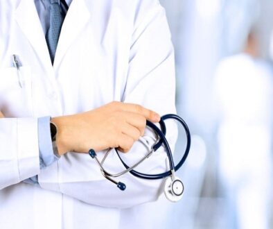 Portrait an unknown male doctor holding a stethoscope behind